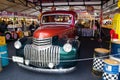 Vintage Chevrolet pickup truck in green-orange has parking as a decoration at a Zippy Market, Central world shopping center.